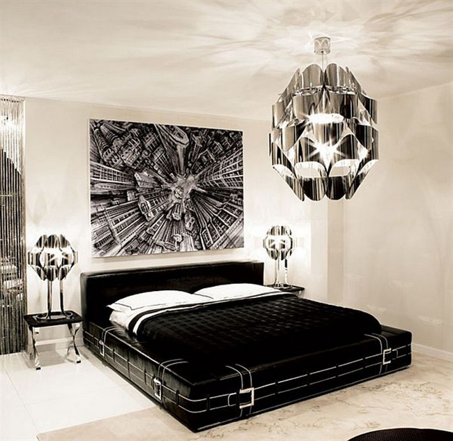 Contemporary black and white bedroom with shiny silver chandelier and painting above the headboard, which make the room look sophisticated