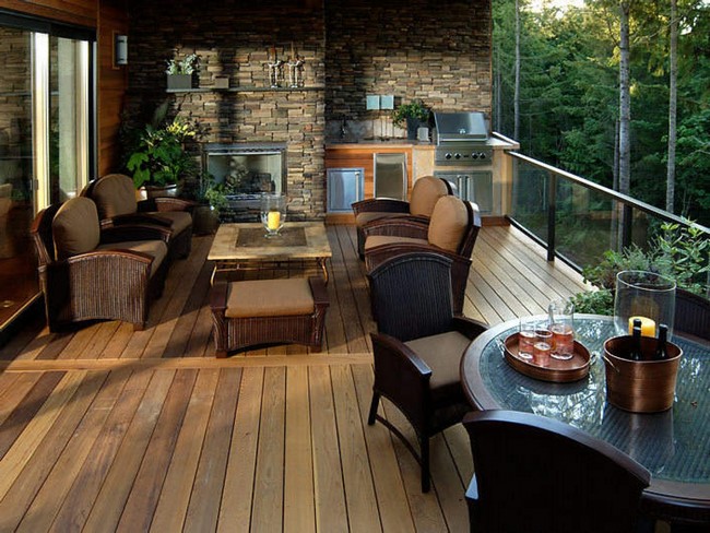 Contemporary wooden terrace with stone fireplace, which creates a warm and welcoming atmosphere
