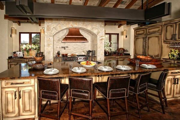 Spanish-style kitchen with cooking alcove and hood