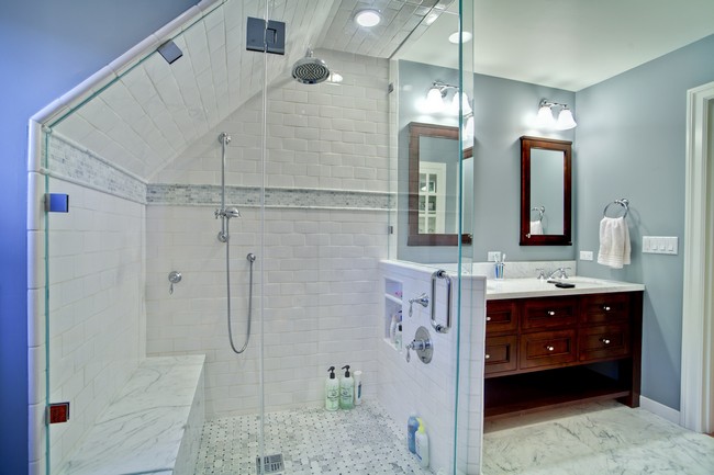 Shower with glass walls underneath section with slanted ceiling 