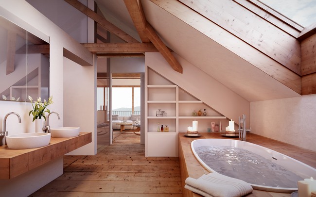 Bathtub directly below window in slanted ceiling