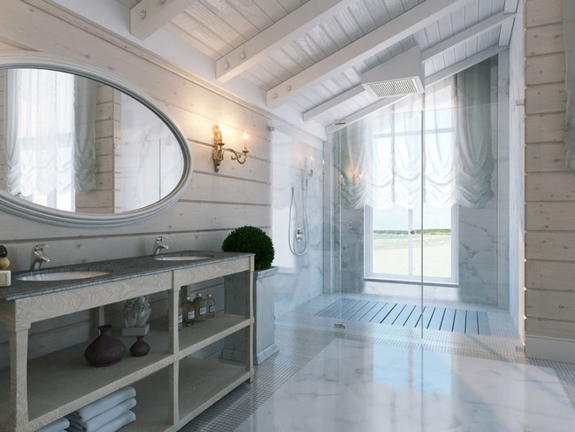 Large oval mirror which reflects light making bathroom appear more airy