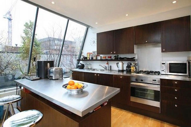 Expansive slanted glass window that offers beautiful views and illuminates the kitchen
