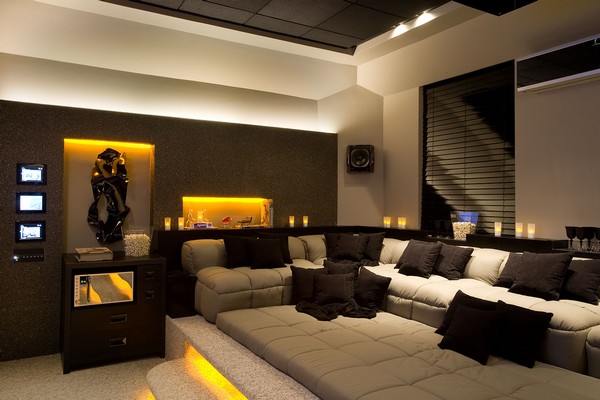 Home theater  in a black and white color scheme, with candles and LED lighting for illumination and a window with dark blinds