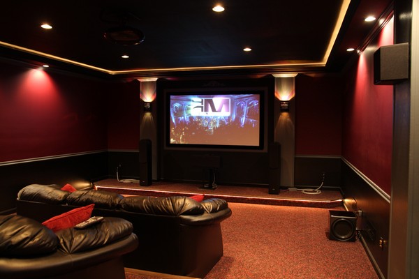 Home theater with drywall painted in bold and dark colors