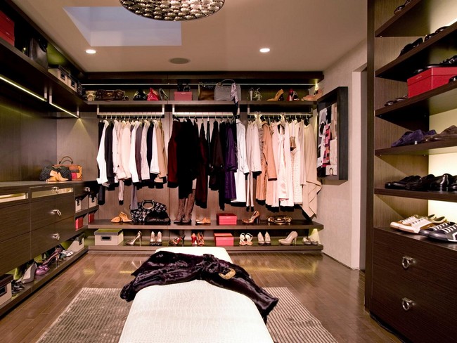Hardwood flat-panel cabinets and shelving used to create order in this walk-in-closet