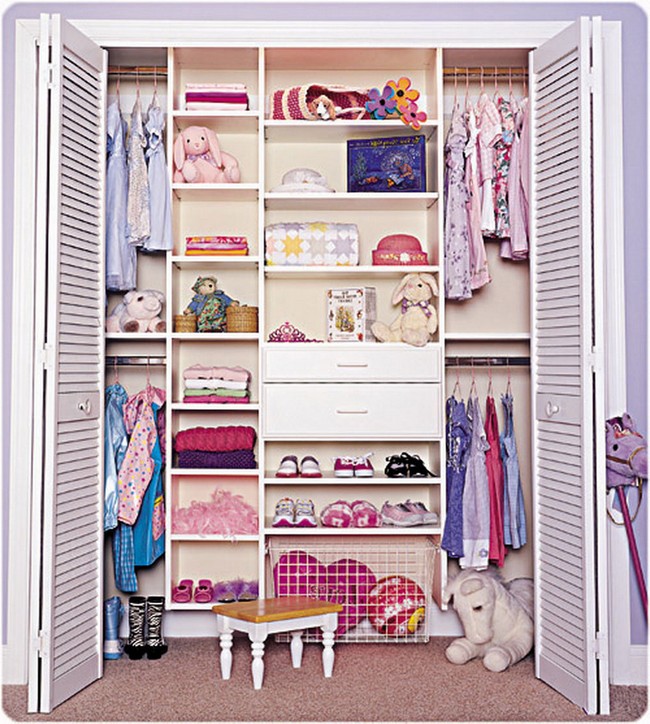 Small walk-in-closet with a rug and stuffed animals, accessorizing the small space beautifully