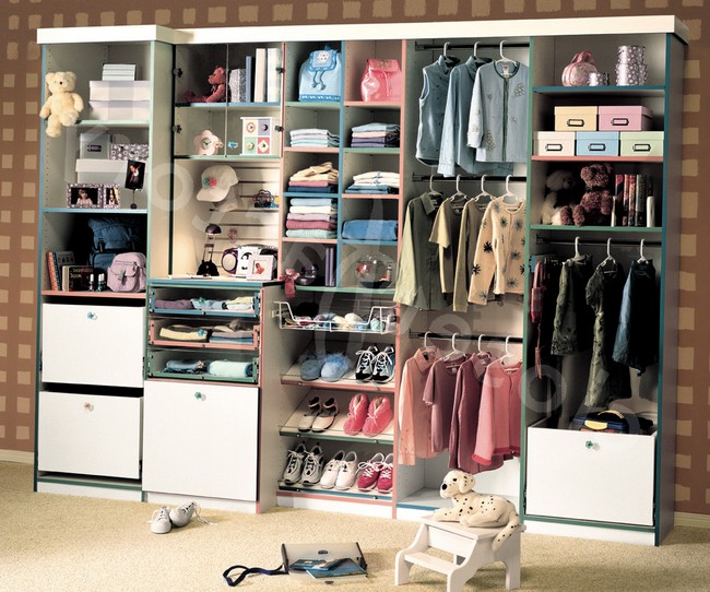 Highly organized closet surrounded by wallpaper in a neutral shade