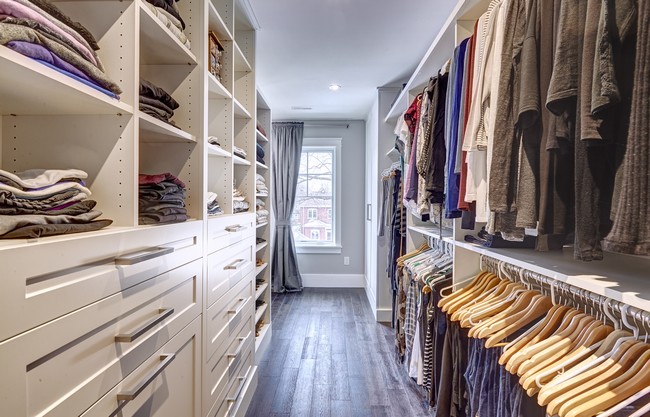 Large walk-in-closet with blue and white color scheme, creating a bold and masculine appearance
