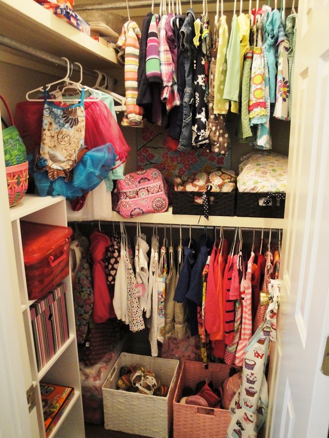 Colorful clothes hanging in this closet help set a cheerful mood