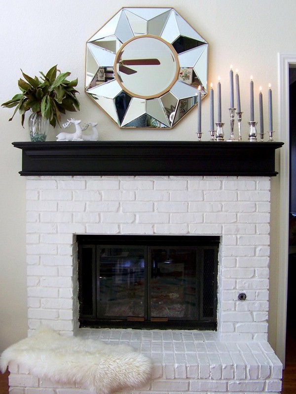 Elegant shiny mirror on fireplace mantel