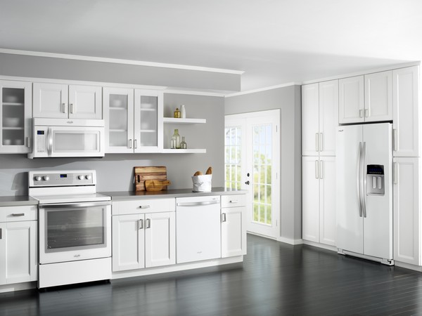 White spacious kitchen with dark grey hardwood floor
