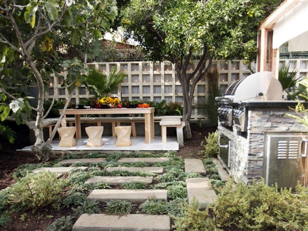 Outdoor kitchen with trees, shrubs and flowers