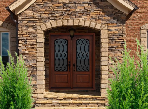 Double wooden door surrounded by stone wall and floor